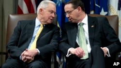 Attorney General Jeff Sessions speaks with Deputy Attorney General Rod Rosenstein, during the opening of the summit on Efforts to Combat Human Trafficking at Department of Justice in Washington, Feb. 2, 2018.