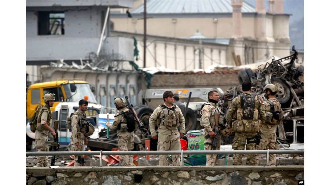 FILE - In this Tuesday, April 19, 2016 file photo, Afghan security forces inspect the site of a Taliban-claimed deadly suicide attack in Kabul, Afghanistan.