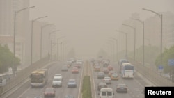 Vehicles are seen on roads during a dust storm in Beijing, China, May 4, 2017. 