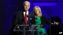 FILE - Vice President Joe Biden, left, and Jill Biden speak at "It Always Seems Impossible Until It Is Done: A Night of Music with ONE and (RED)", in celebration of World AIDS Day, at Carnegie Hall.