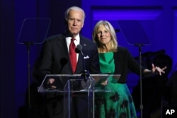 FILE - Vice President Joe Biden, left, and Jill Biden speak in celebration of World AIDS Day at Carnegie Hall in New York, Dec. 1, 2015.