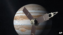 NASA's Juno spacecraft passes in front of Jupiter in this artist's depiction