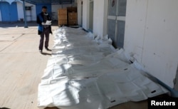 Bags containing dead bodies of migrants who were killed in a truck crash, are seen at a hospital in Bani Walid town, Libya, Feb. 14, 2018.