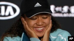 Japan's Naomi Osaka answers questions at a press conference following her win over Karolina Pliskova of the Czech Republic in their semifinal at the Australian Open tennis championships in Melbourne, Australia, Thursday, Jan. 24, 2019. 