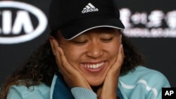 Japan's Naomi Osaka answers questions at a press conference following her win over Karolina Pliskova of the Czech Republic in their semifinal at the Australian Open tennis championships in Melbourne, Australia, Thursday, Jan. 24, 2019. 