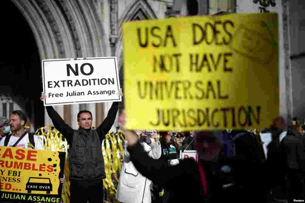 Supporters of Wikileaks founder Julian Assange protest outside the Royal Courts of Justice in London.