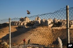 Palestinian laborers work at a construction site in a new housing project in the Israeli settlement of Maale Adumim, near Jerusalem, Feb. 7, 2017.