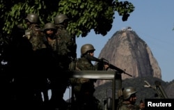 Brazilian marines patrol the streets of Botafogo neighborhood with Sugar Loaf mountain in the background in Rio de Janeiro, Brazil, April 3, 2018.
