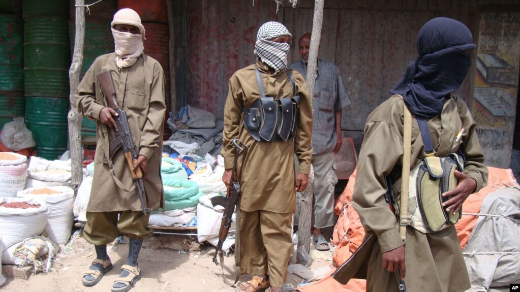 FILE - Armed Al-Shabab fighters patrol in Mogadishu, Somalia, June 29, 2009. 