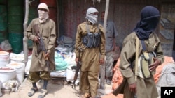 FILE - Armed Al-Shabab fighters patrol in Mogadishu, Somalia, June 29, 2009. Somalia's al-Shabab militants announced Dec. 21, 2018, a military offensive aimed at getting rid of Islamic State-related militants in the country.