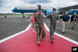 Joint Chiefs Chairman Gen. Joseph Dunford is welcomed by Lt. Gen. Jerry Martinez, center right, as he arrives at Air Base in Fussa, Japan, Aug. 13, 2017, for a refueling stop.