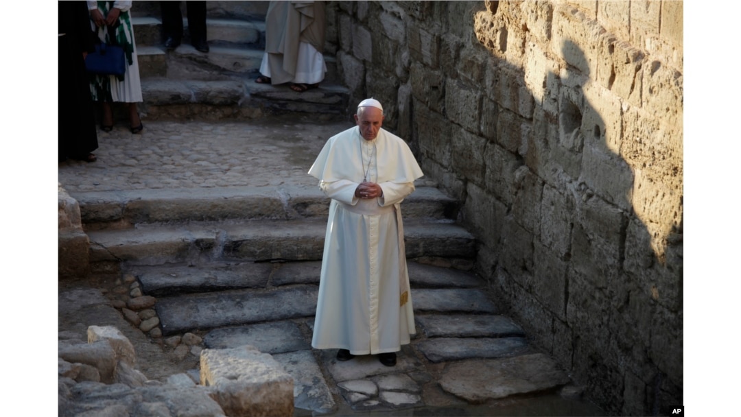 Pope Francis prays as he visits the Bethany beyond the Jordan, which many believe is the traditional site of Jesus' baptism, in South Shuna, Jordan, May 24, 2014.