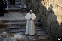Pope Francis prays as he visits the Bethany beyond the Jordan, which many believe is the traditional site of Jesus' baptism, in South Shuna, Jordan, May 24, 2014.