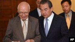 Visiting Chinese Foreign Minister Wang Yi, right, and Pakistan's adviser on foreign affairs Sartaj Aziz, left, leave after a press conference, in Rawalpindi, Pakistan, June 25, 2017. 