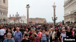 FILE - Tourists are seen at St. Mark's Square in Venice, Italy, April 15, 2018. (REUTERS/Manuel Silvestri/File Photo)