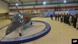 Iran's newest fighter jet, Qaher-313, or Dominant-313, is unveiled by Iranian President Mahmoud Ahmadinejad, accompanied by top officials during a ceremony, in Tehran, Iran, Saturday, Feb. 2, 2013. Ahmadinejad unveiled the country's newest fighter jet, wh