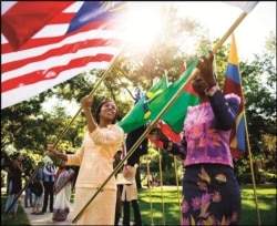 International students wave their national flags at the University of Missouri in Columbia, Missouri.