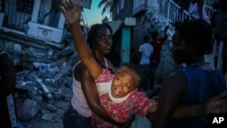 Oxiliene Morency cries out in grief after the body of her 7-year-old-daughter Esther Daniel was recovered from the rubble of their home destroyed by the earthquake in Les Cayes, Haiti, Saturday, Aug. 14, 2021. 