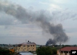 FILE - Black smoke rises above Juba, South Sudan, July 10, 2016.