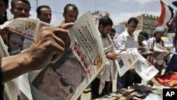 Anti-government protesters read local newspapers featuring a photograph of Vice President Abed Rabbo Mansour Hadi, and a headline that reads in Arabic, 'What's After Ali Abdullah Saleh', in Sana'a, Yemen, June 7, 2011