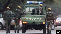 Zimbabwean soldiers who are thought to be escorting President Robert Mugabe leave a private hospital in Harare, Zimbabwe, on Thursday, June, 16, 2011. (AP Photo/Tsvangirayi Mukwazhi)