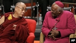 The Dalai Lama, left, sits with Archbishop Desmond Tutu, of South Africa, Tuesday, April 15, 2008 prior to speaking at the University of Washington in Seattle. (AP Photo/Ted S. Warren)