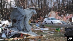 Sheet metal from a home is seen wrapped around a tree in Brookport, Illinois., after tornado hit the small town Sunday, Nov. 17, 2013.
