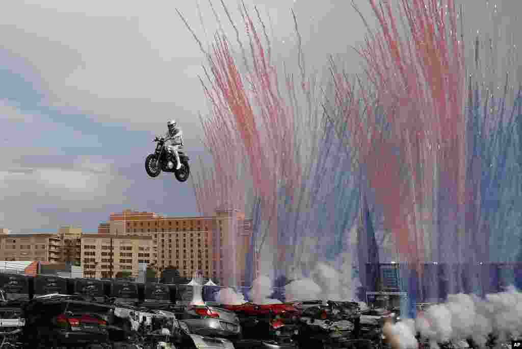 Travis Pastrana jumps a row of crushed cars on a motorcycle, July 8, 2018, in Las Vegas, Nevada.