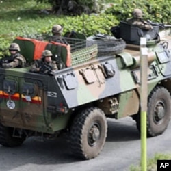 A French armored vehicle patrols a street in Abidjan Mar 31 2011