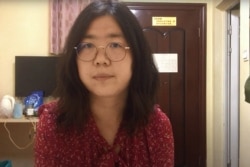 FILE - This screengrab taken Dec. 28, 2020, from an undated video shows former Chinese lawyer and citizen journalist Zhang Zhan as she broadcasts via YouTube, at an unconfirmed location in China. (AFP Photo/You Tube)