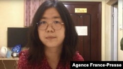(FILE )This file screengrab taken on Dec. 28, 2020 from an undated video showing former Chinese lawyer and citizen journalist Zhang Zhan as she broadcasts via YouTube, at an unconfirmed location in China. 