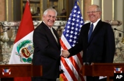 U.S. Secretary of State Rex Tillerson, left, shakes hands with Peru's President Pedro Pablo Kuczynski after a private meeting at the government palace in Lima, Peru, Feb. 6, 2018.