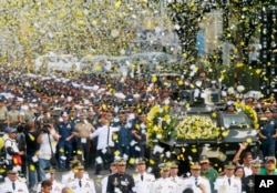 FILE - Yellow confetti rain on the military component during the 30th anniversary celebration of the "People Power Revolution" that toppled the late strongman Ferdinand Marcos and helped install Corazon "Cory" Aquino to the presidency, Feb. 25, 2016, at suburban Quezon city, northeast of Manila.