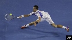 Serbia's Novak Djokovic makes a forehand return to Britain's Andy Murray during the men's singles final at the Australian Open tennis championships in Melbourne, Australia, January 30, 2011.