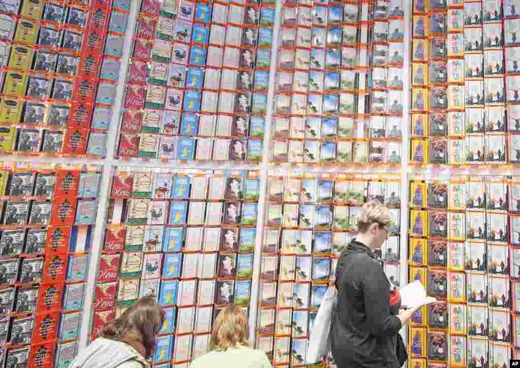 Visitors read books during the Leipzig International Book Fair in Leipzig, Germany. More than 2,000 exhibitors from 42 countries present their novelties from March 13 until March 16, 2014.