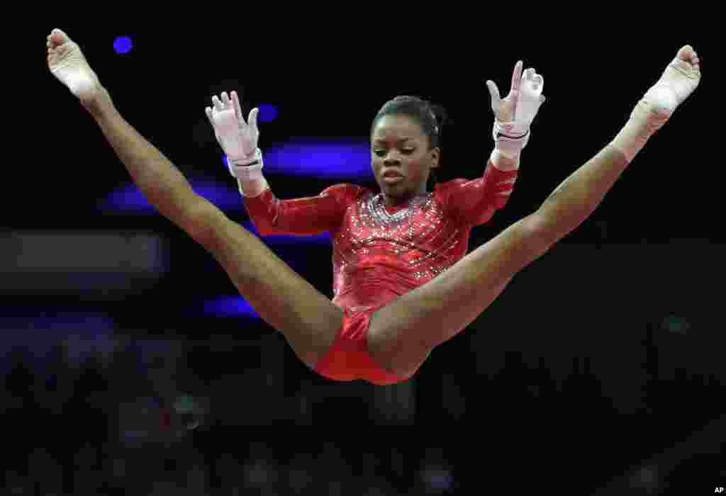 U.S. gymnast Gabrielle Douglas perfroms on the uneven bars during the Artistic Gymnastics women's team final at the 2012 Summer Olympics, July 31, 2012, in London. 