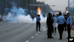 Pakistani police fire tear gas to stop protesters from marching towards the parliament building in Islamabad, March 27, 2016.