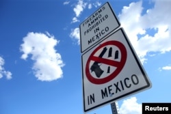 A sign warning drivers that firearms and ammunition are prohibited in Mexico is seen at the U.S.-Mexico border in Nogales, Arizona, Oct. 9, 2016.