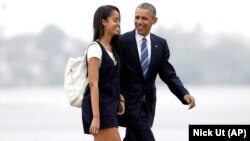 FILE - President Barack Obama and his daughter Malia walk from Marine One toward Air Force One in 2016. Malia is attending Harvard University after a gap year.