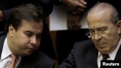 FILE - Brazil's Lower House President Rodrigo Maia and Brazil's Chief of Staff Eliseu Padilha look at signatures used by Federal deputies of opposition in protest against pension reform, Brasilia, Feb. 5, 2018. 