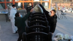 FILE - A worker delivers food to residents under lockdown following the coronavirus disease (COVID-19) outbreak in Xian, Shaanxi province, China Dec. 29, 2021.