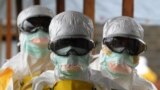 Health care workers, wearing protective suits, leave a high-risk area at the French NGO Medecins Sans Frontieres (Doctors without borders) Elwa hospital on Aug. 30, 2014 in Monrovia.
