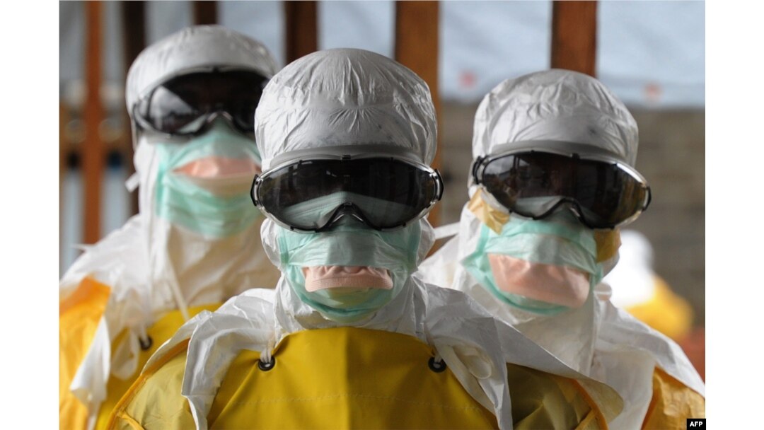 Health care workers in protective suits leave a high-risk area at a Monrovia hospital run by Doctors Without Borders on Aug. 30, 2014.