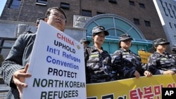South Korean activists stage a protest outside the Chinese embassy in Seoul urging Beijing to stop repatriating refugees who flee hunger or repression in North Korea. About 30 activists including former refugees chanted slogans like "Stop forced repatriat