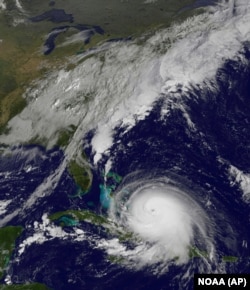This satellite image taken Oct. 1, 2015, at 9:37 a.m. EDT, and released by the National Oceanic and Atmospheric Administration (NOAA), shows Hurricane Joaquin. The Category 4 hurricane pounded lightly populated islands of the eastern Bahamas Thursday.