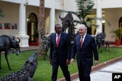 U.S. Secretary of State Rex Tillerson, right, walks with Kenya's President Uhuru Kenyatta, left, past metal sculptures of animals, inside State House in Nairobi, Kenya, March 9, 2018.
