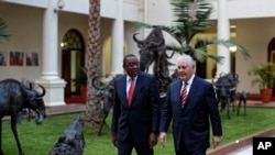 U.S. Secretary of State Rex Tillerson, right, walks with Kenya's President Uhuru Kenyatta, left, past metal sculptures of animals, inside State House in Nairobi, Kenya, March 9, 2018. 