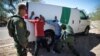 FILE - Border Patrol agents arrest migrants who crossed the U.S.-Mexico border in the desert near Ajo, Ariz., Sept. 11, 2018. 