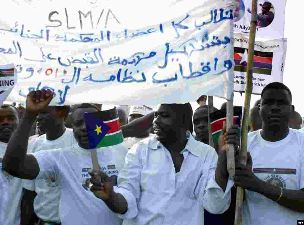 A former child soldier holds a gun while taking part in a child soldiers' release ceremony, outside Yambio, South Sudan.