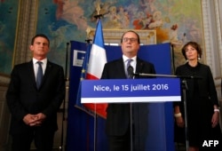 French President Francois Hollande, center, with Prime Minister Manuel Valls, left, and Minister of Health Marisol Touraine delivers a speech the day after the Bastille Day truck attack, in Nice, southern France, July 15, 2016.